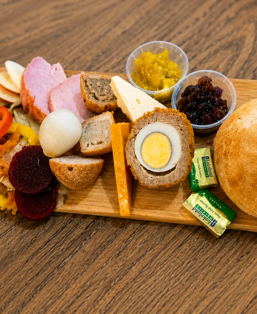 A ploughman-style board with bread, salad and savoury bites